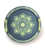 Navy round wooden tray with gold handles and central floral mandala design.