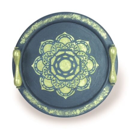 Navy round wooden tray with gold handles and central floral mandala design.