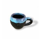 Turquoise Civilization handmade ceramic mug with glossy black base and turquoise blue rim glaze.