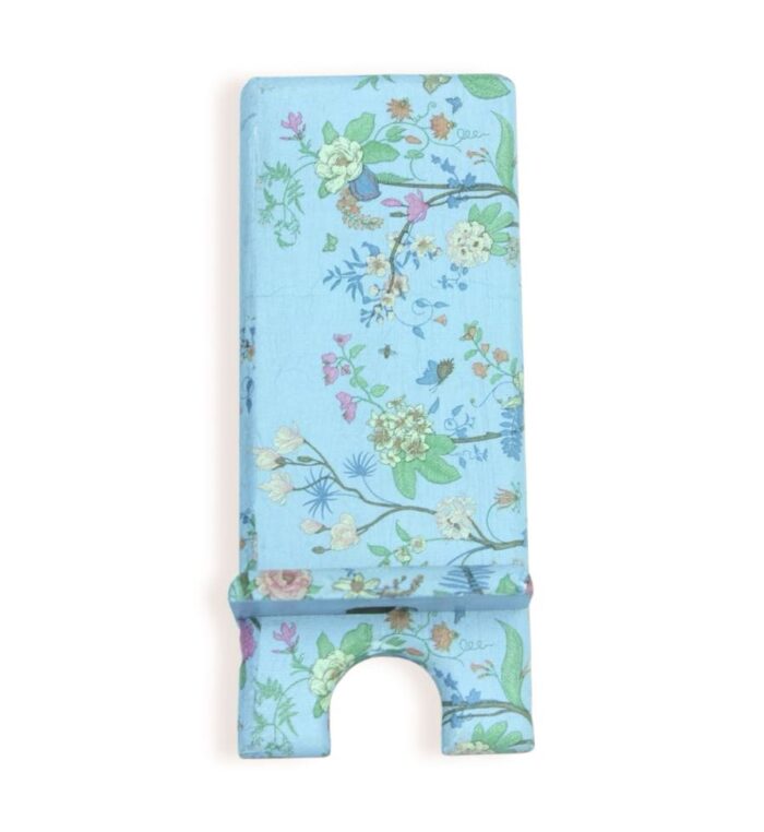 Front view of a decorative phone stand with a light blue background and detailed floral pattern in pastel colors