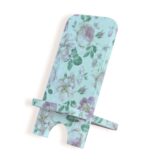 Side view of a decorative phone stand with soft floral pattern in pastel pink, green, and white tones.