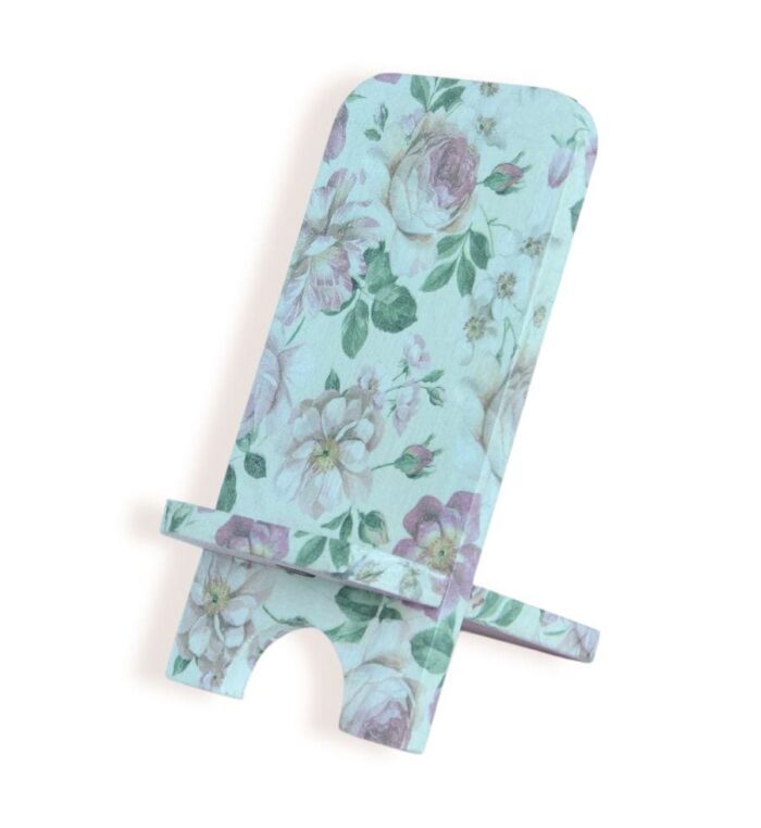 Side view of a decorative phone stand with soft floral pattern in pastel pink, green, and white tones.