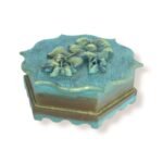 Side view of a closed handcrafted wooden box with scalloped edges and golden floral details.