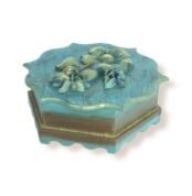 Side view of a closed handcrafted wooden box with scalloped edges and golden floral details.