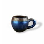 Hidden Treasures handcrafted ceramic mug with metallic blue and bronze glaze finish.