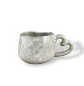 Handmade ceramic mug with heart-shaped handle by Pulse Civilization in textured white finish.