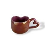 Depth History handcrafted ceramic mug with heart-shaped handle in glossy maroon glaze.