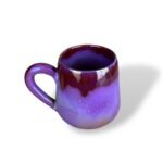 Glossy purple ceramic mug with deep burgundy glaze flowing from the rim, creating a rich contrast and regal effect.