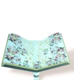 Close-up top view of floral elegance wooden stand with intricate cut-out design and rose patterns.