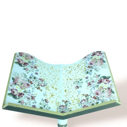 Close-up top view of floral elegance wooden stand with intricate cut-out design and rose patterns.