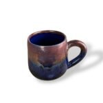 Handcrafted ceramic mug with a glossy two-tone glaze, ideal for cozy morning coffee moments.