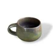 Handcrafted ceramic mug with a rich, earthy green finish, reflecting natural elegance and artistry.