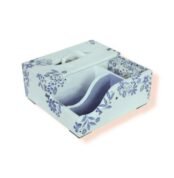 Side angle view of decorative wooden organizer box with blue floral patterns, featuring compartments and tissue holder.