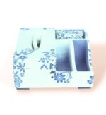 Front view of decorative wooden organizer box with blue floral patterns, showing tissue holder and compartments.