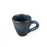 Charm of Pottery handmade ceramic mug with deep blue glaze and subtle bronze highlights.