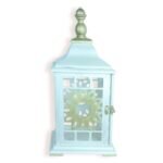Front view of vintage pastel blue lantern with sunburst cut-out design and metallic top.