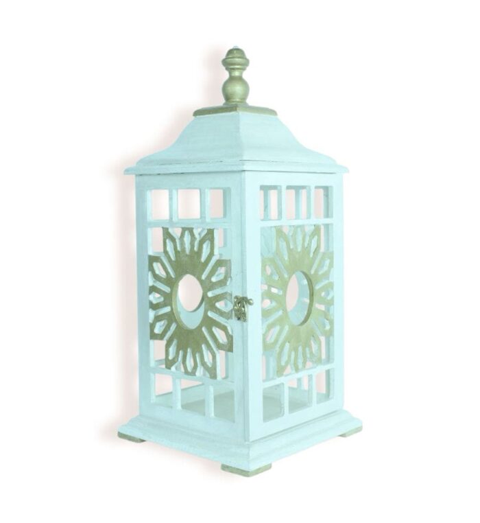 Front angled view of vintage pastel blue lantern with sunburst cut-out design and metallic top.