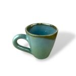 Pharaonic Imprint handmade ceramic mug with turquoise green glaze and subtle golden rim accents.