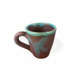Magic of Silt handmade ceramic mug with earthy brown base and turquoise glaze accents.
