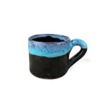 Heritage of the Land handmade ceramic mug with matte black base and turquoise blue rim glaze.
