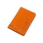 top view of a light Havana brown leather passport cover with embossed ancient Egyptian deity figures.