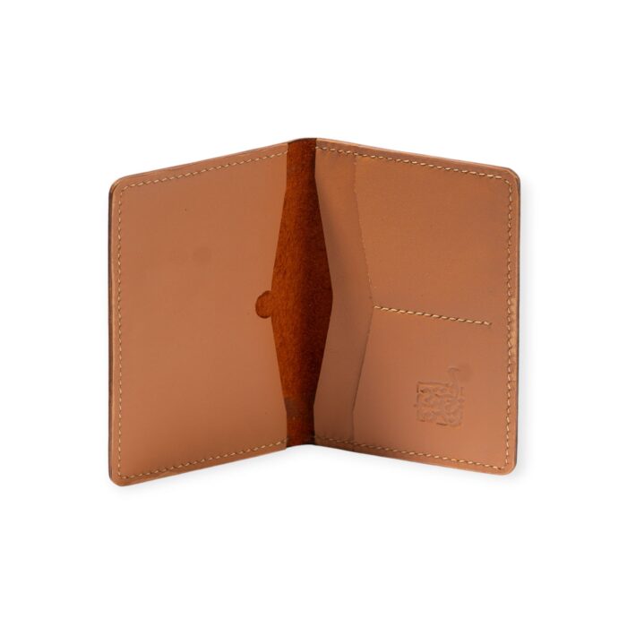 Open view of a Havana leather passport cover embossed with ancient Egyptian gods and symbols.