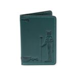 Closed green leather card holder with an embossed figure of the ancient Egyptian sun god Ra.
