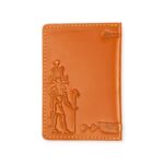 Closed view of a light Havana brown leather passport cover with embossed ancient Egyptian deity figures.