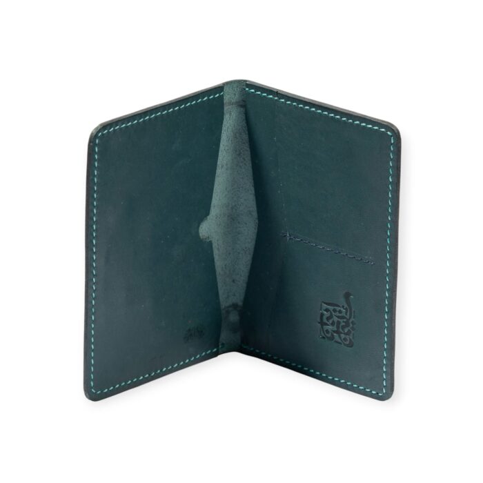 Open view of a green leather passport cover embossed with ancient Egyptian deities and sacred symbols.