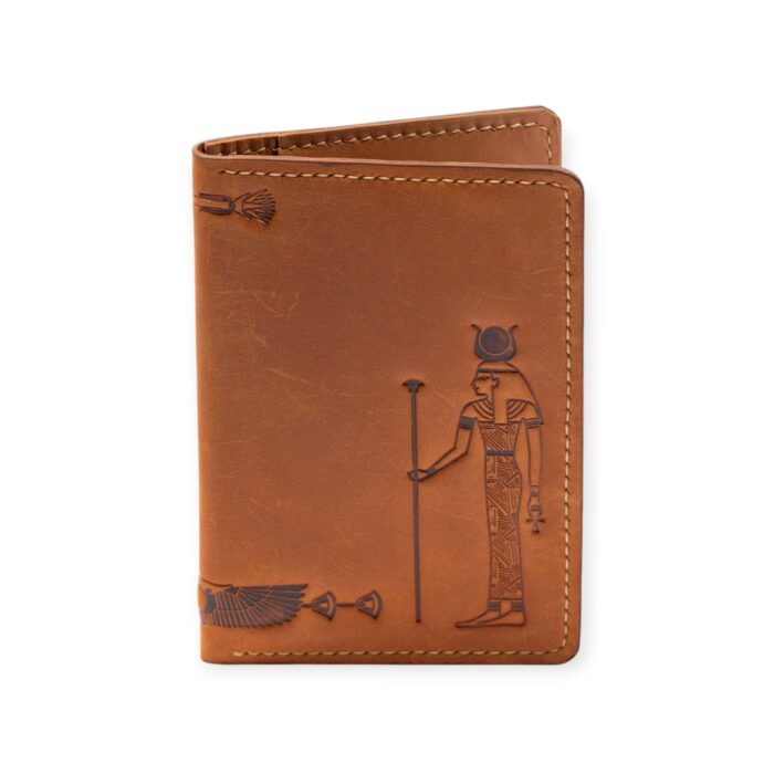 Closed view of a Havana brown leather passport cover with embossed ancient Egyptian deity figures.