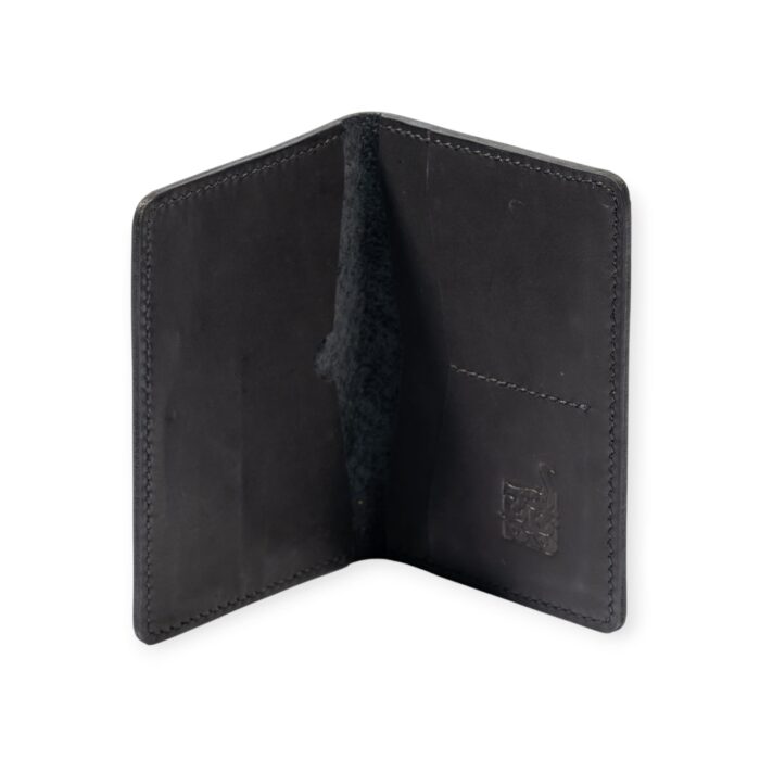 Open view of a black leather passport cover embossed with ancient Egyptian deities and sacred symbols.