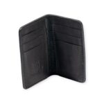 Black leather Mega Card Holder opened with embossed geometric pattern and contrast stitching.