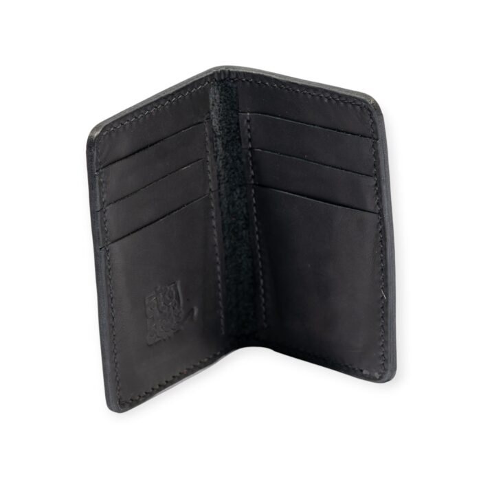 Black leather Mega Card Holder opened with embossed geometric pattern and contrast stitching.