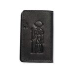 Closed black leather card holder featuring an embossed ancient Egyptian figure design.