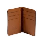 Open view of a small Havana brown leather card holder with six card slots and visible stitching.