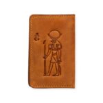 Closed view of a handcrafted Light Havana leather card holder embossed with the ancient Egyptian god Ra.