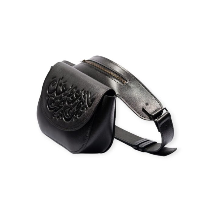 Black leather waist bag with embossed Arabic calligraphy, angled side view.