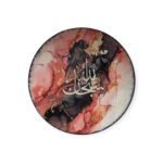 Decorative porcelain plate with Arabic calligraphy and abstract marbled background in red and black.