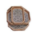 Set of octagonal Andalusian wooden trays with floral mosaic inlays.