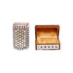 Curved wooden box with intricate geometric patterns inlaid with mother-of-pearl, showing the interior.