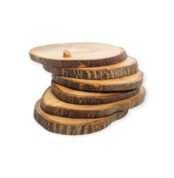 Stack of natural rustic wooden slices with bark edges, arranged in a staggered pile with a small peg on top