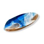 Angled view of oval wood resin centerpiece showing blue and white resin waves from the left side.