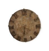 Vintage round wall clock with Roman numerals and intricate golden engravings.