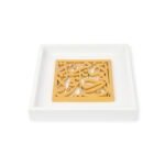 Square oriental wooden panel with Arabic calligraphy placed inside a white tray