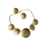 Radiant Disc jewelry set with gold-tone hammered discs featuring necklace and earrings on white background