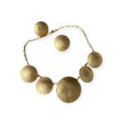 Radiant Disc jewelry set with gold-tone hammered discs featuring necklace and earrings on white background