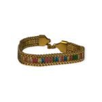 Gold bracelet with colorful rectangular gems in a chevron setting on white background