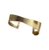 Twisted Hammered Cuff bracelet in gold-tone metal with textured finish on white background