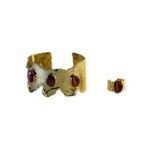 Crimson Ember Set with hammered gold-tone cuff and red gemstone ring on white background