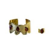 Crimson Ember Set with hammered gold-tone cuff and red gemstone ring on white background